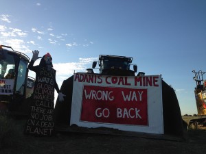 Protesters lock themselves to machinery to halt work starting at the Adani coal mine